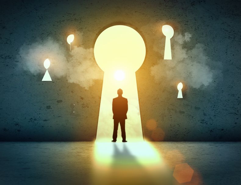  silhouette of businessman standing in keyhole sun shining above