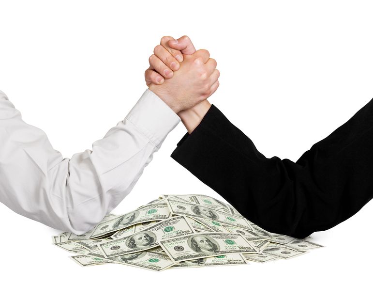 two men arm wrestling over a pile of money illustrating the concept of negotiation
